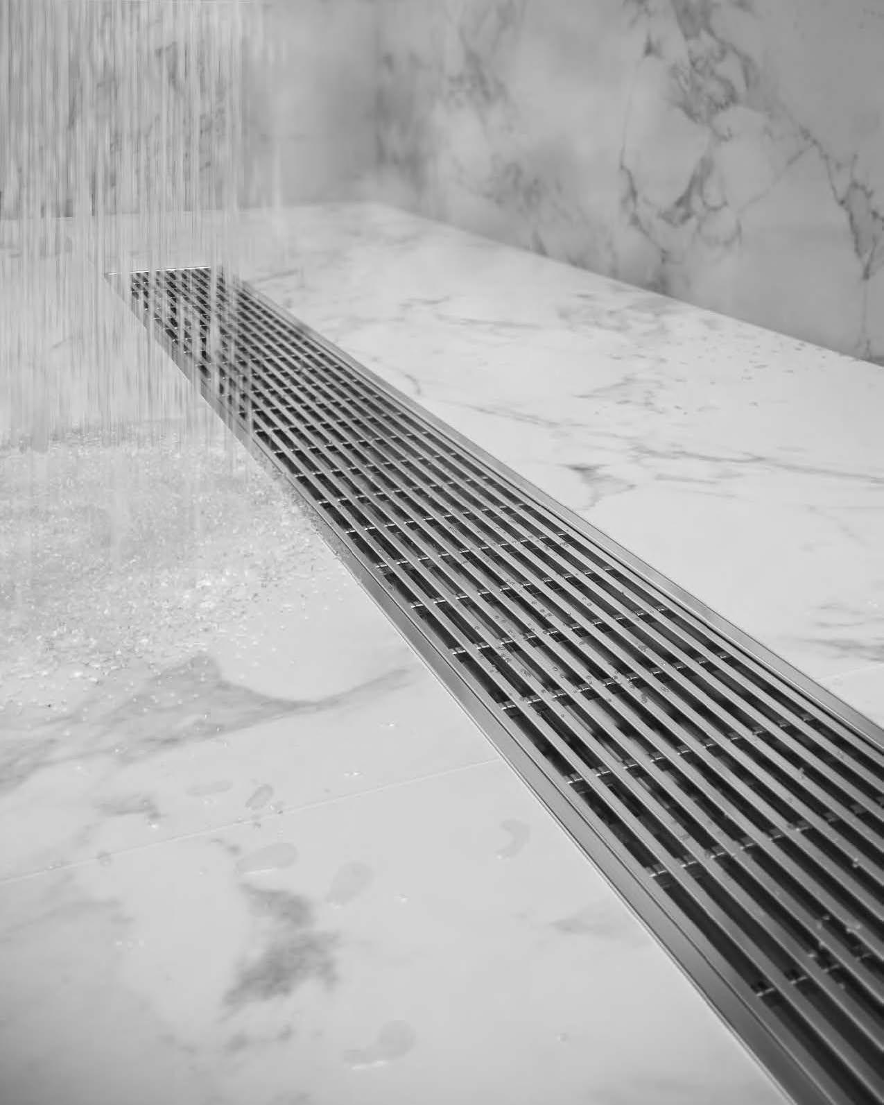 QM Drain's Wedgewire Linear Drain, influenced by naturally exposing forms and pushing raw materials beyond the wire. Easy to install, easy to clean, and works for both indoor and outdoor showers. #QMDrain #luxuryshowers #showertile #lineardrains