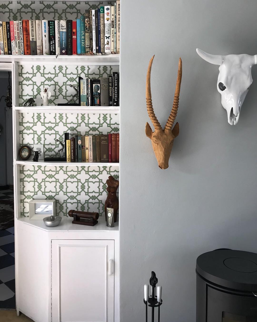 Wallpaper on the back of bookshelf for a pop of colour. #hertex #interiors