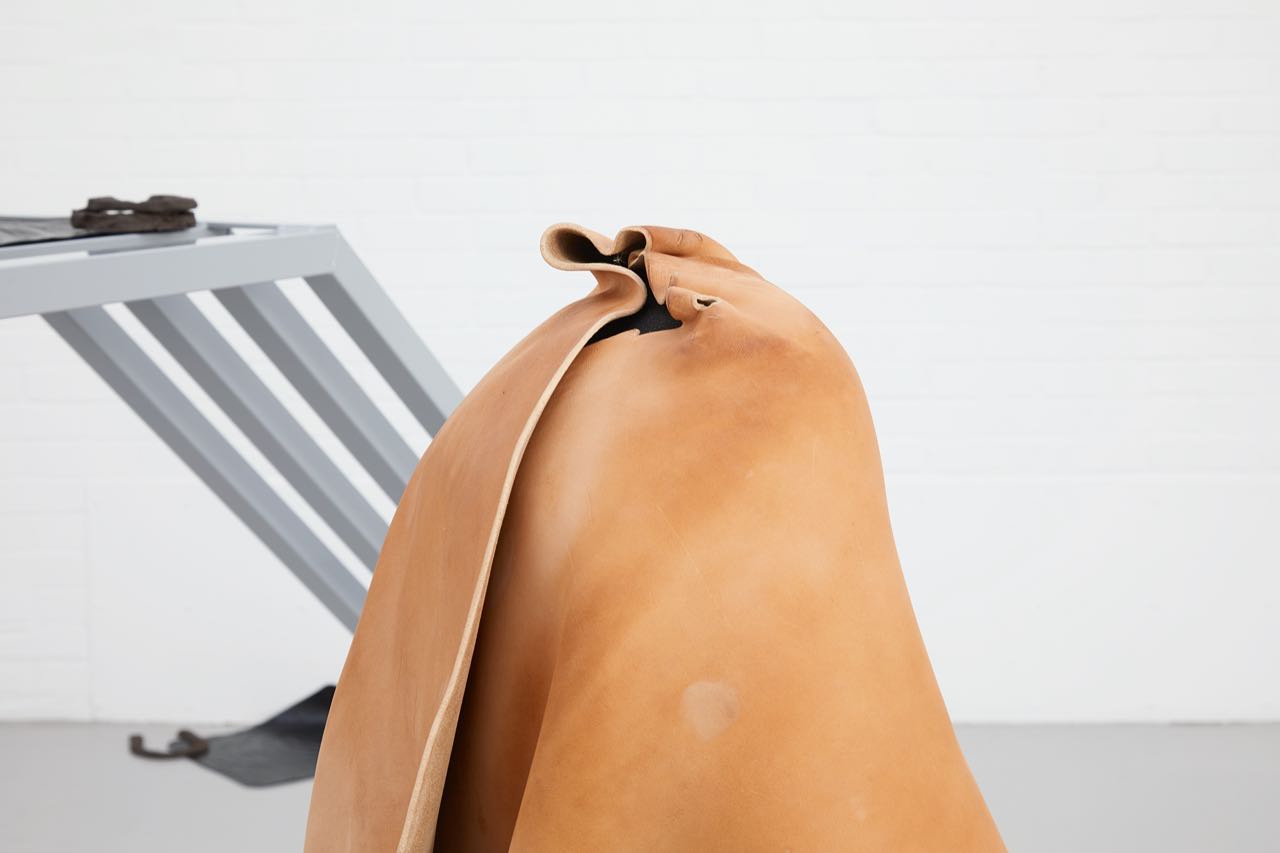 Harriet Bowman (@harrietbowman), detail of, ‘and the atoms began to freely pass to the larger body’ (2018), car seat, steel tubing, wet moulded leather hide. (Photography by Stuart Whipps)