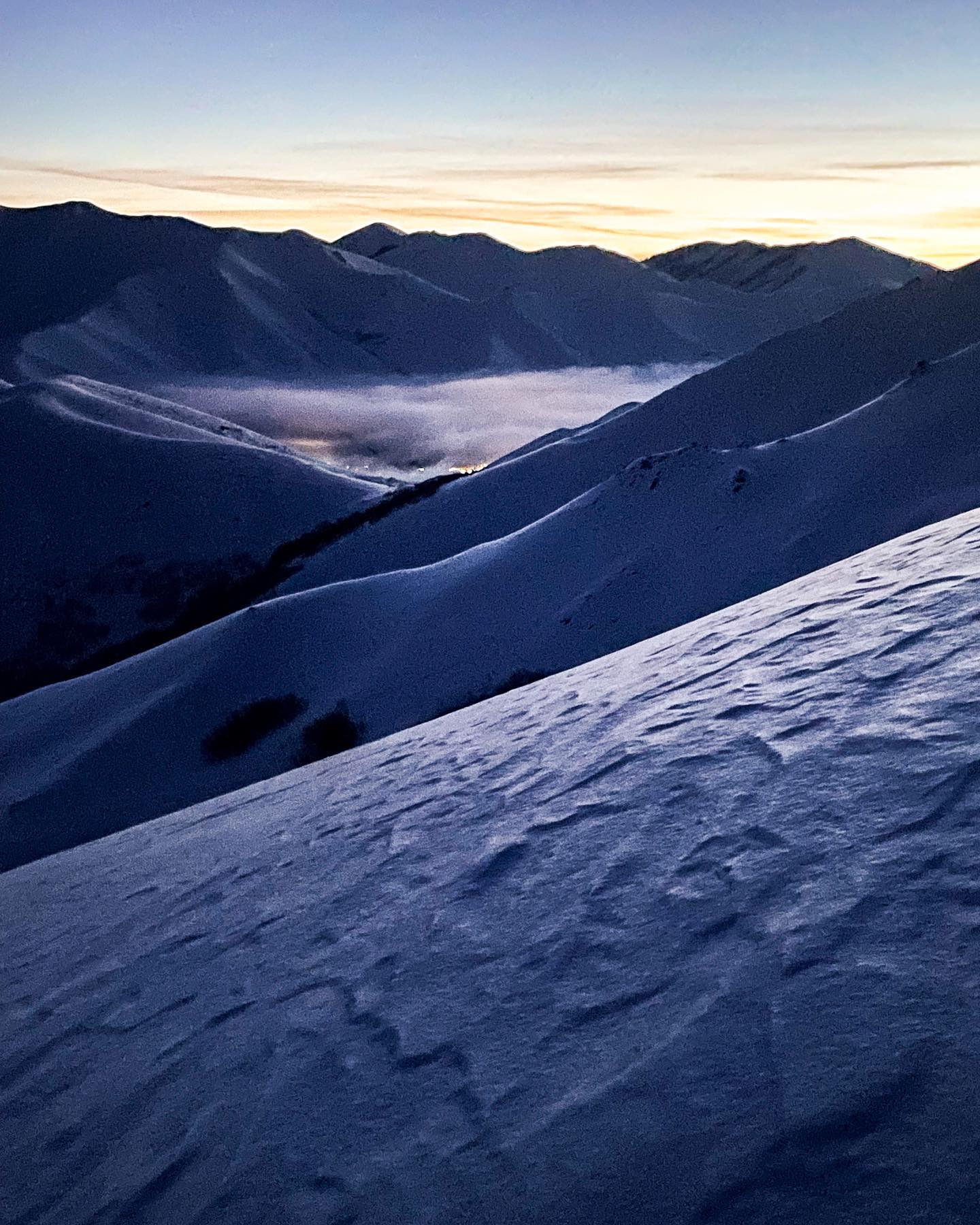 Dawn this morning while out exploring the hills above town was beautiful. The valley fog reached north obscuring humankind from view. I always enjoy considering the scenes before me which have towns, roads, homes in them as they would have been before the 1800’s. #skitouring #skitour #dawnpatrol #backcountryskiing #skiing #landscapephotography #westernlandscape #dawn #sunrise #mountains #sastrugi #fog #texture