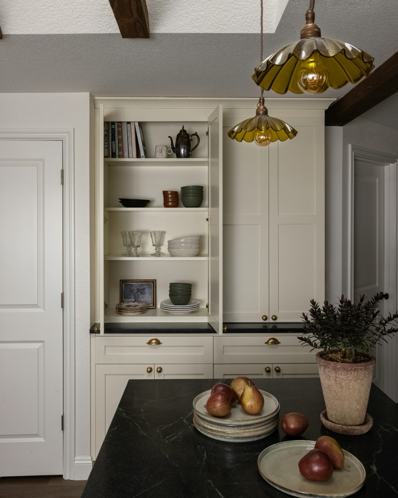 This kitchen feels like a quiet moment in time. Warm, storied, and effortlessly elegant. The handcrafted brass knobs and pulls complement the rich soapstone beautifully, proving once again that lighting and hardware are the jewelry of the home. ✨💖
Would you love a kitchen like this, or are you team modern minimalism? Let me know in the comments!