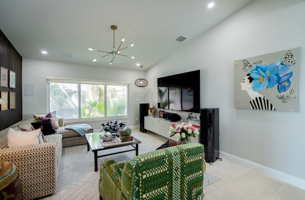 Right next to the TV, there’s a painting that steals the spotlight—an incredible piece by pop artist Ashley Longshore. Her signature boldness, a woman’s face framed by a cascade of blue flowers and butterflies, brings so much energy and joy to the room. It’s playful, powerful, and impossible to ignore. This purchase was very personal to me- a celebration of my divorce that was a long time coming. I knew making it through that terrible time that a piece of art would come to me and Ashley’s piece just spoke to me. It was a woman in all of her feminine energy- elegant and strong, ready to embrace her newfound freedom and reclaim her sense of self. It’s perfection and I adore seeing it every day as a reminder of strength and resilience.