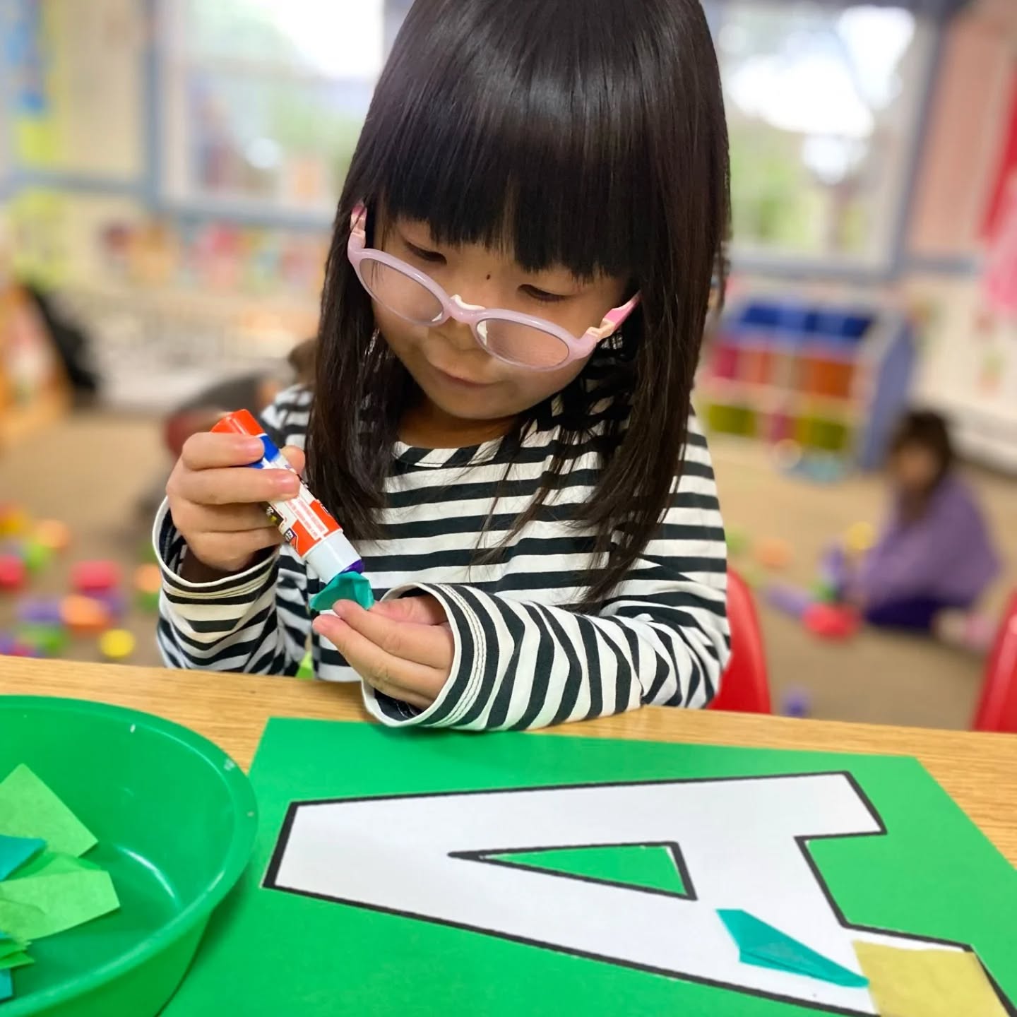 Our PK students develop their fine motor skills with many different types of activities, like using glue sticks with tissue paper. #preschoolactivities #finemotordevelopment #funwithlearning #veritasatelmwood