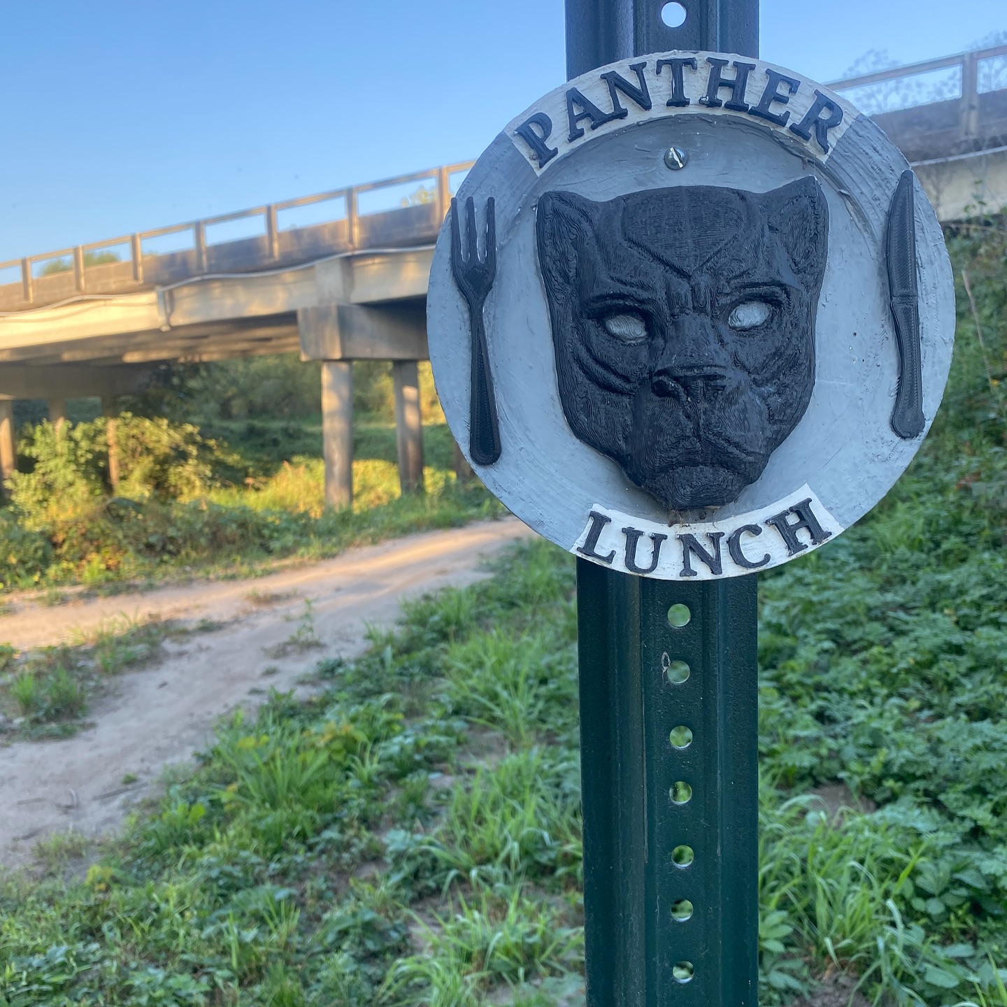 We just found someone has put up this amazing Panther Lunch trailhead marker and it made us think hey, maybe y’all want to hear the tale of how the name came to be! Last year we were preparing for our annual shop trail building day with Coralville Parks & Rec. We were having a group text discussion of trail day logistics when autocorrect turned “Pancheros Lunch will be provided by Coralville” into “PANTHER LUNCH”. Of course we all had a good laugh over this. When trail day came and we all sat down on the rocks to enjoy our lunch, it was decided that this would be the name of the new trail! 🐆 🥙. Thank You to whoever made the awesome sign, we can’t wait for this years upcoming trail day!