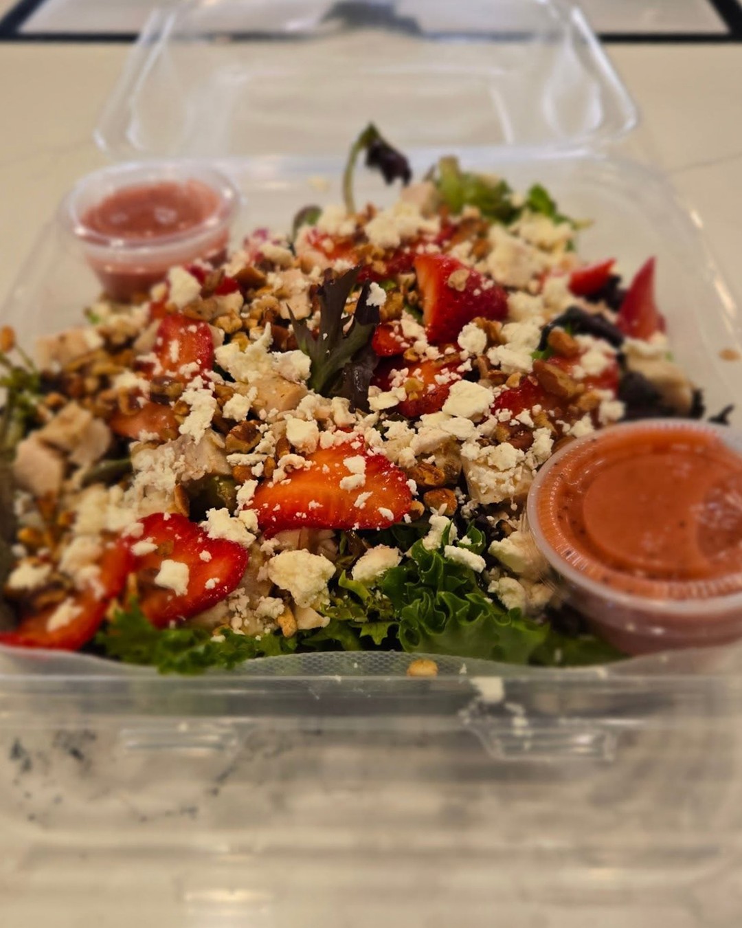 Fresh meets indulgent at Poppy Seed Bakery. Their new Strawberry Chicken Salad is stacked with spring mix, grilled chicken, strawberries, pecans, feta, and a house-made strawberry vinaigrette. It’s crisp, light, and exactly what you want when you're thinking about balance.
And if that balance includes a chocolate chip cookie... make it one of theirs. They're award-winning for a reason.