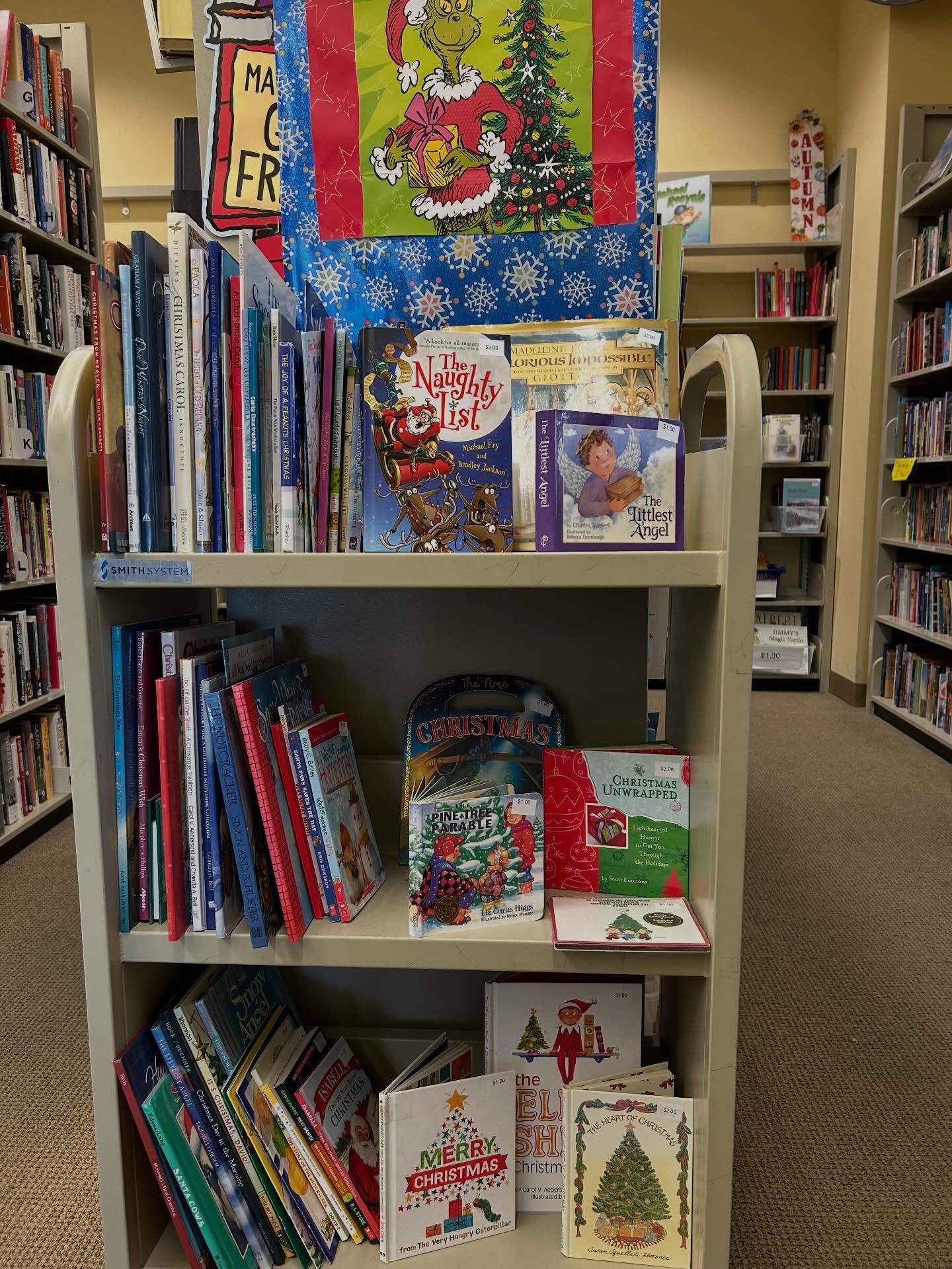 The endcap cart in the children’s corner of the bookstore is packed with wonderful holiday books. There’s Christmas and Hanukkah and Kwanzaa and winter., All for $.50 to three dollars. There are gift quality books in the corner and at the cashiers counter there are even more.
On the blue cart outside the bookstore, there are two shelves of holiday books for 50 cents or a dollar.
On Tuesday evening, December 2, there will be holiday books on sale from 5:30 to 7:30 in the community room. Santa is visiting for stories at 6 PM.#friendsofthecamarillolibrary #holidaybooks#childrensbooks