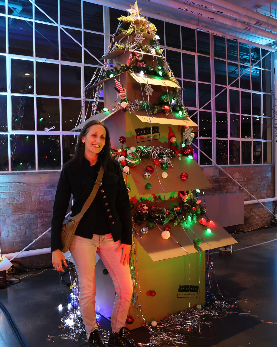 🌲Exhibiting Artist Spotlight
Fausta Facciponte (she / her)
UNBOXED: A Celebration in Layers
Artist Statement
This work explores the holiday season as a ritual of unpacking —both literal and metaphorical. The installation, a tree formed from stacked storage boxes, invites curiosity and play, with glowing lights revealing glimpses of ornaments and keepsakes. Sourced from thrift stores and donations, it becomes a collective arrangement, weaving multiple histories into a single layered experience and giving new life to discarded objects. The textures, organized chaos, and subtle surprises reflect the joy of discovery and the connections shared across generations, celebrating memory, community, and the layered stories embedded in holiday objects.
Interview Excerpt
Produced in Partnership with @modernmississauga
I’m a professional artist exhibiting my work in group and solo shows. I’m based in Mississauga, working independently and on community-based projects.
My art practice revolves around collecting, arranging, and re-presenting objects. I work primarily in photography and installation, and I’m really interested in material culture and our relationship with the material world. A lot of my work is about freeing objects from their familiar contexts and inviting people to see them in a new way … or maybe just really look at them. Visually, my work tends to move between minimalist and maximalist aesthetics. I’m drawn to both extremes, and sometimes I like to let them coexist in the same piece. That tension feels exciting to me.
Alongside my studio practice, I teach at the University of Toronto and Sheridan College. I mentor emerging artists both through institutions and voluntarily, and I also support community artists through independent curatorial projects.
🎟️ PWYC, suggested donation: $5.00
📸: Images 1 + 3, Gabriella Bank / Sanborg Productions. Images 2, Courtesy the artist.
#Mustsee #Lastchance #Exhibition#ContemporaryArt
#MFT2025 #SAIB