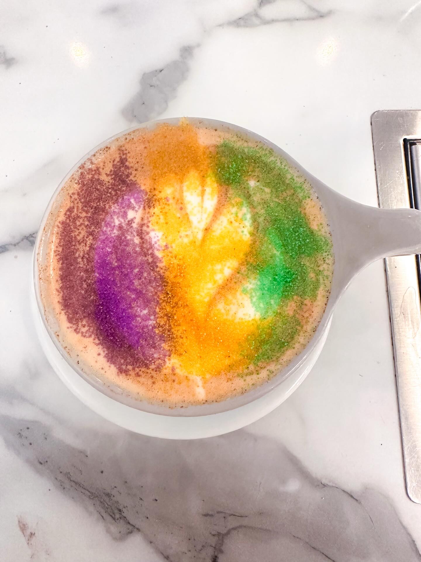 The King Cake Latte is a looker! Come get in the mood for Mardi Gras! 🪅💜💛💚😖🎭