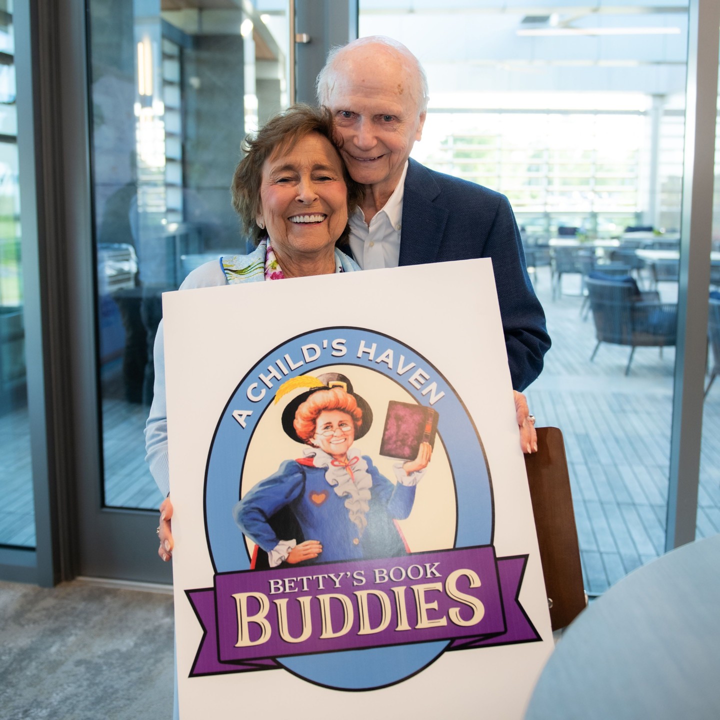 Today, we are overflowing with gratitude as we honor our beloved, long-time ACH volunteer and supporter, Betty Farr. Betty selflessly gave time and resources to A Child’s Haven for many years. To our ACH family, among other accolades, she represented the model volunteer. When asked to help, Betty always said YES with an enthusiastic and genuinely caring spirit. Her love for children shined on her face, and her joy in giving was contagious, impacting everyone around her. This led to the creation of The Betty Farr Volunteer Spirit Award, which annually recognizes an ACH volunteer that reflects the commitment, sincere generosity, and caring spirit modeled so beautifully by Betty.
Through the years, Betty would regularly delight the children served by A Child’s Haven by engaging them in animated story times. More recently, we initiated a new program called Betty’s Book Buddies, designed to develop a love of reading and grow self-esteem through helping children feel valued. The program was named after our community’s cherished Betty, who shared her love of books and reading with children all over Greenville for years.
The identity for Betty’s Book Buddies features a costumed Betty, as she typically appeared when reading to little ones. The painting used to create this identity is priceless, but more so is the woman who made an indelible impact in the lives of vulnerable children served by A Child’s Haven and many other little ones throughout our community. By tirelessly advocating for children, Betty helped to ensure that the futures of countless Greenville boys and girls were filled with hope, happiness, and opportunity. We are forever grateful.